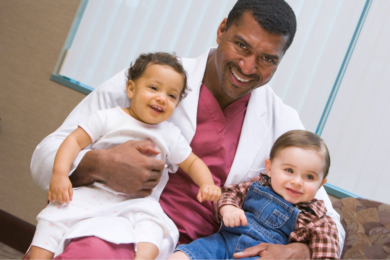 Medical professional with two pediatric patients