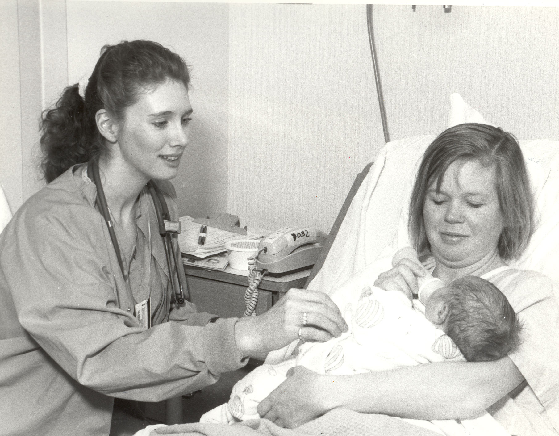 nurse with a mother and her newborn