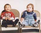two male toddlers on chairs