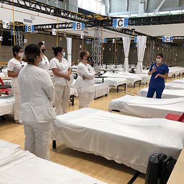 six nurses standing in makeshift ward in San Luis Obispo County gymnasium