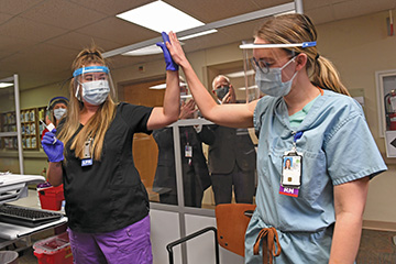 Thera Witte high fiving another female medical professional