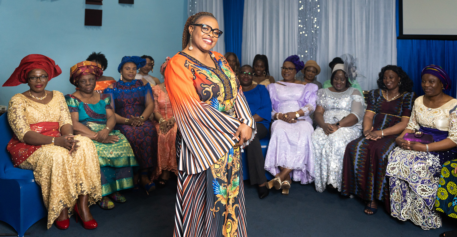 DNP graduate Blessing Azonwu with group of women wearing Nigerian outfits