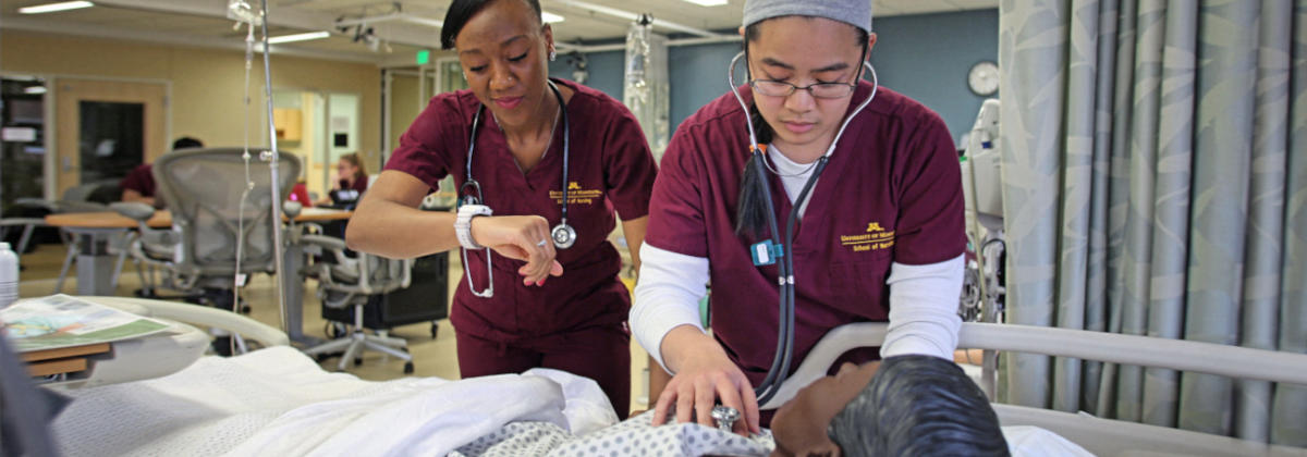 Nursing students assisting a simulation patient