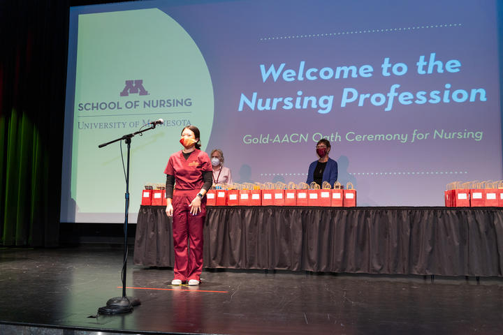Pre-licensure student on Northrop stage for welcome to the nursing profession ceremony