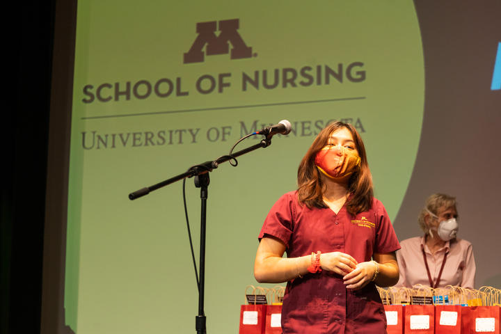 Pre-licensure student on Northrop stage for welcome to the nursing profession ceremony