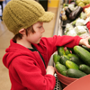 Boy in grocery store produce section